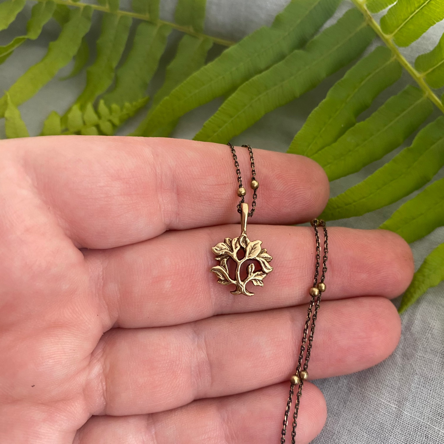 dainty gold-toned tree of life necklace; tiny antiqued brass pendant and chain; gift for nature lover; mythological and Christian symbol