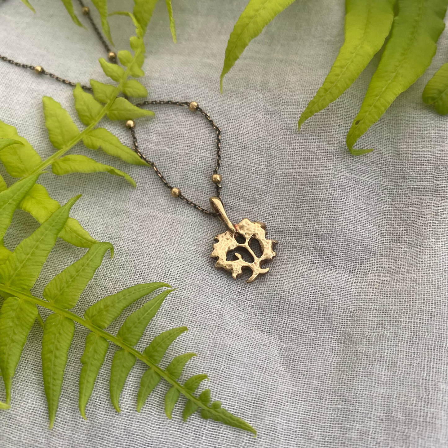 dainty gold-toned tree of life necklace; tiny antiqued brass pendant and chain; gift for nature lover; mythological and Christian symbol