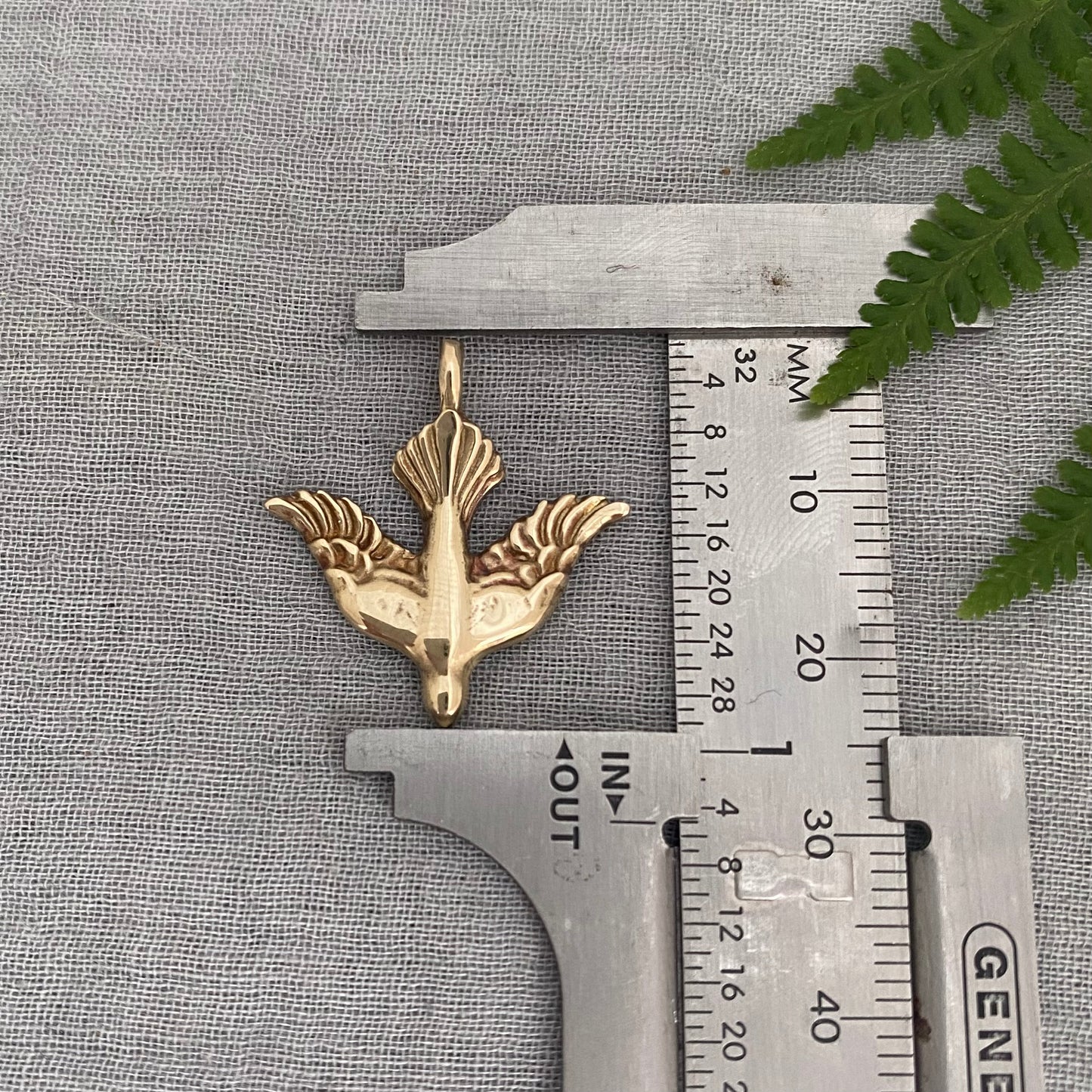 Holy Spirit peace dove pendant necklace gold toned brass dove and chain. It is just under an inch wide and almost an inch long.