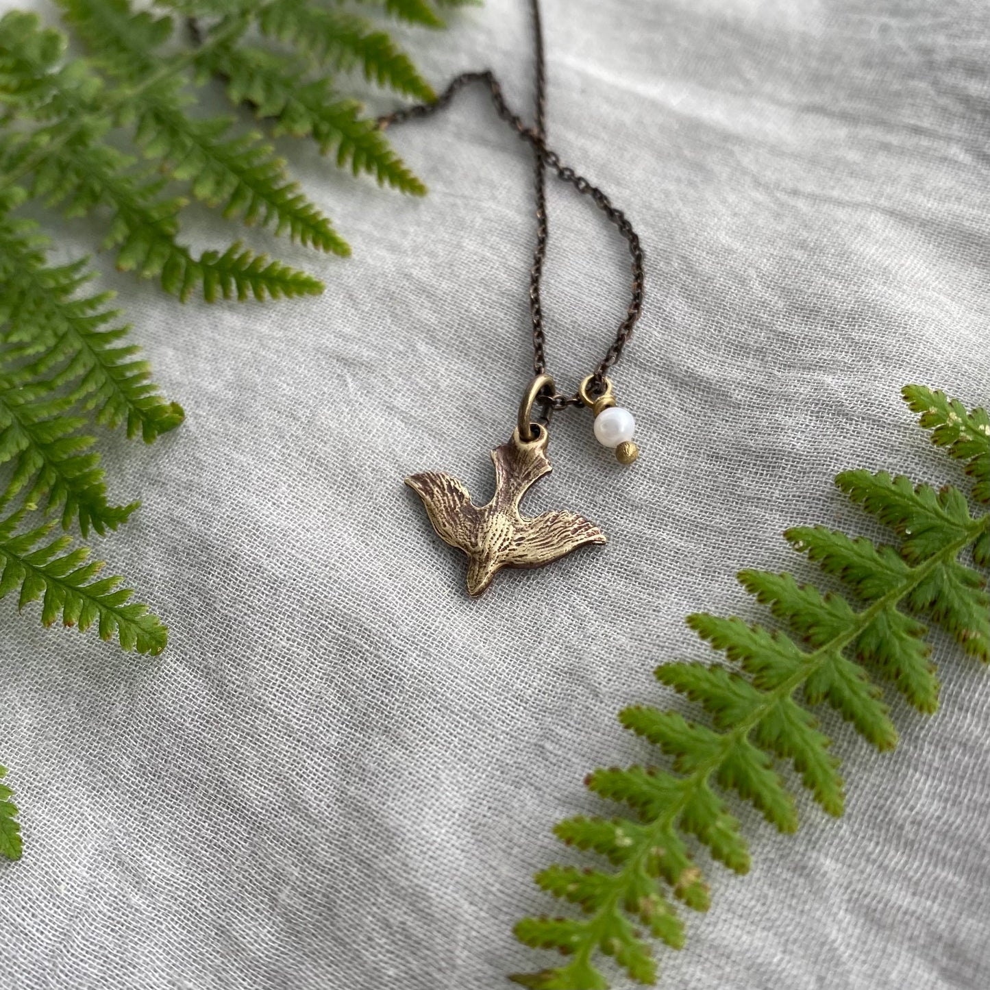 Tiny dainty dove necklace with freshwater pearl; antiqued brass pendant and chain