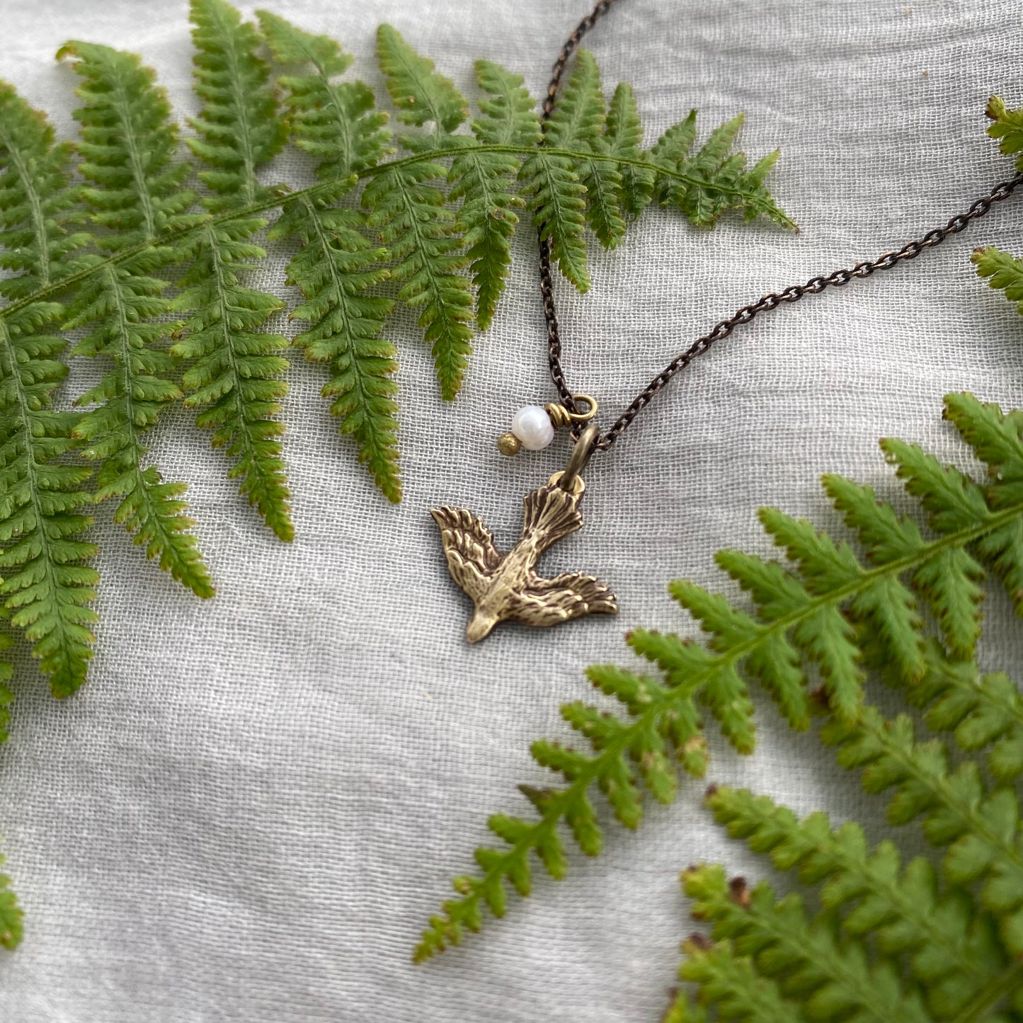 Tiny dainty dove necklace with freshwater pearl; antiqued brass pendant and chain
