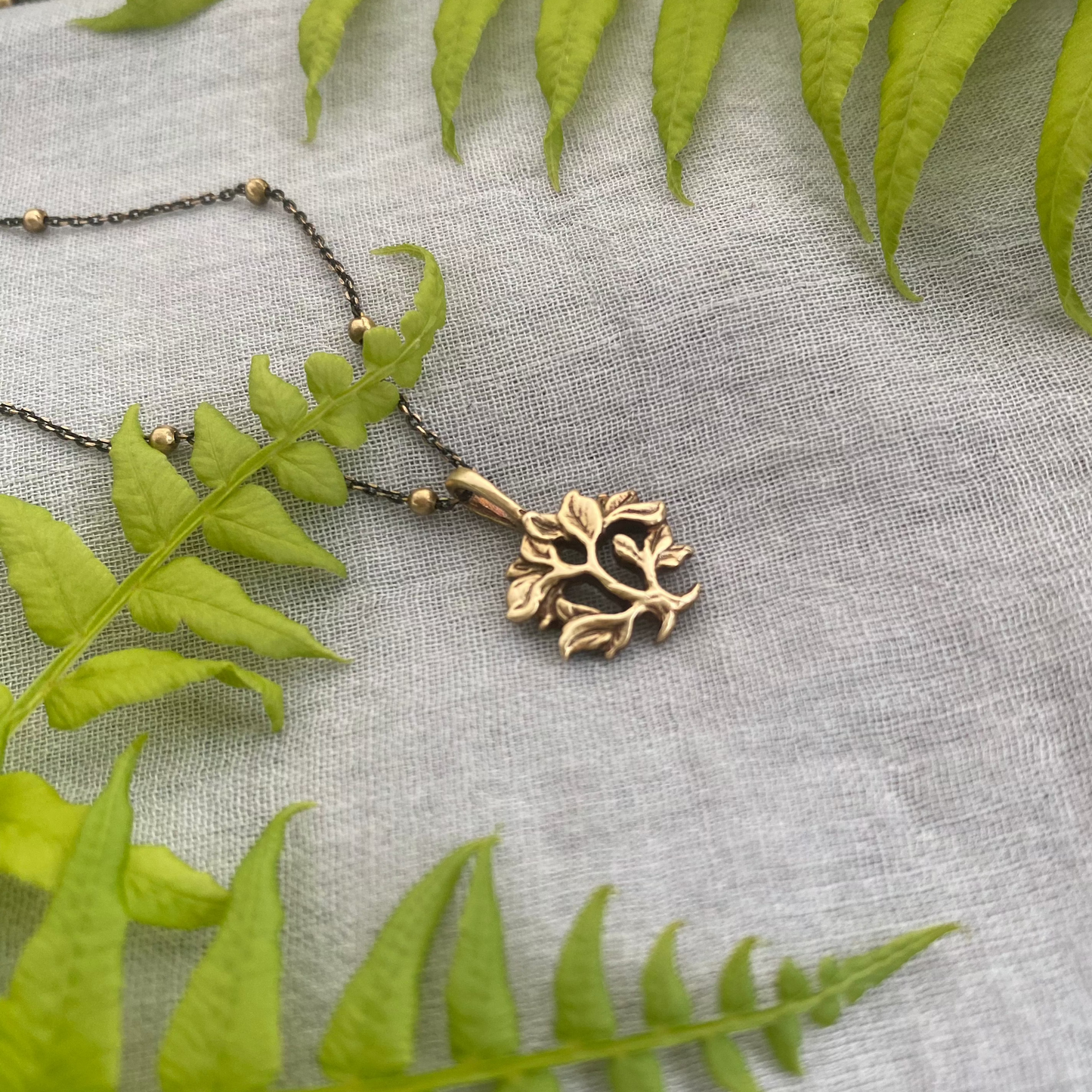 dainty gold-toned tree of life necklace; tiny antiqued brass pendant and chain; gift for nature lover; mythological and Christian symbol