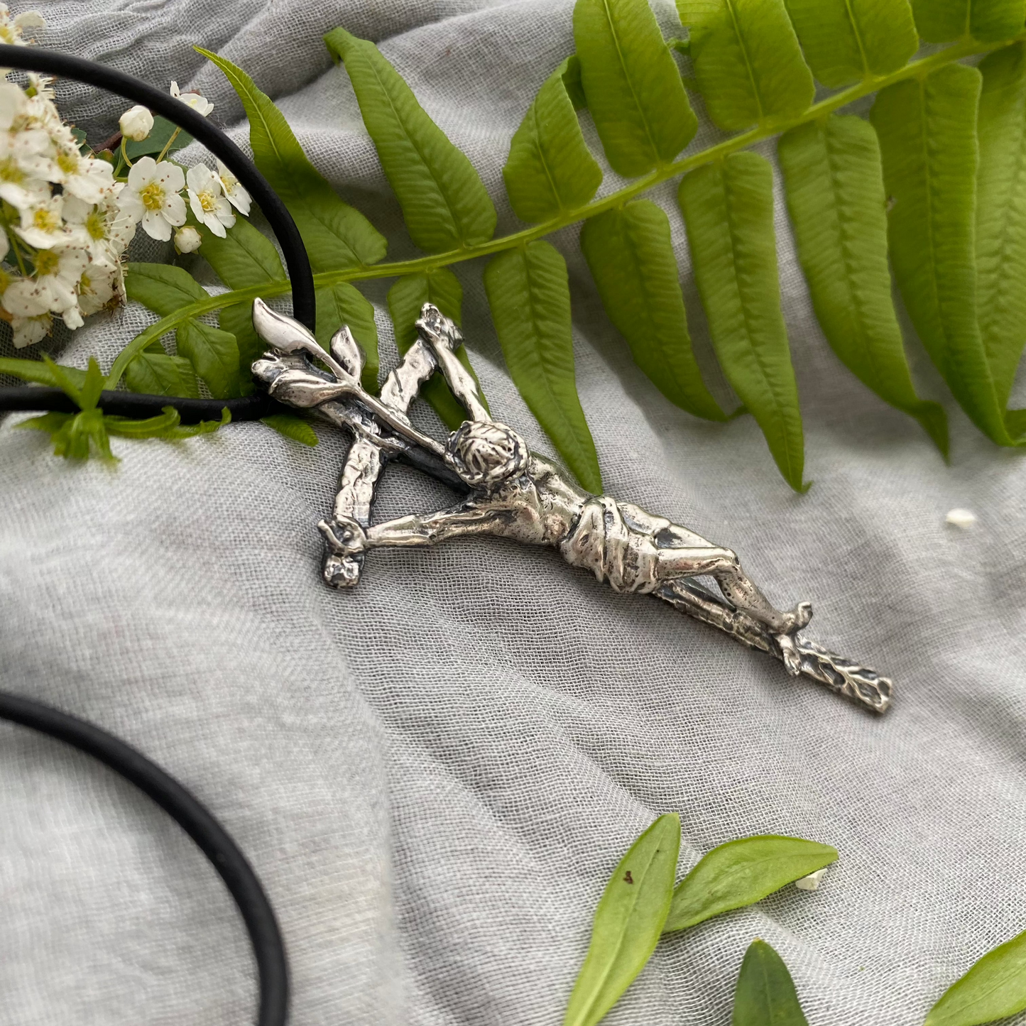 large sterling silver crucifix on black leather cord with realistic corpus and leeaves