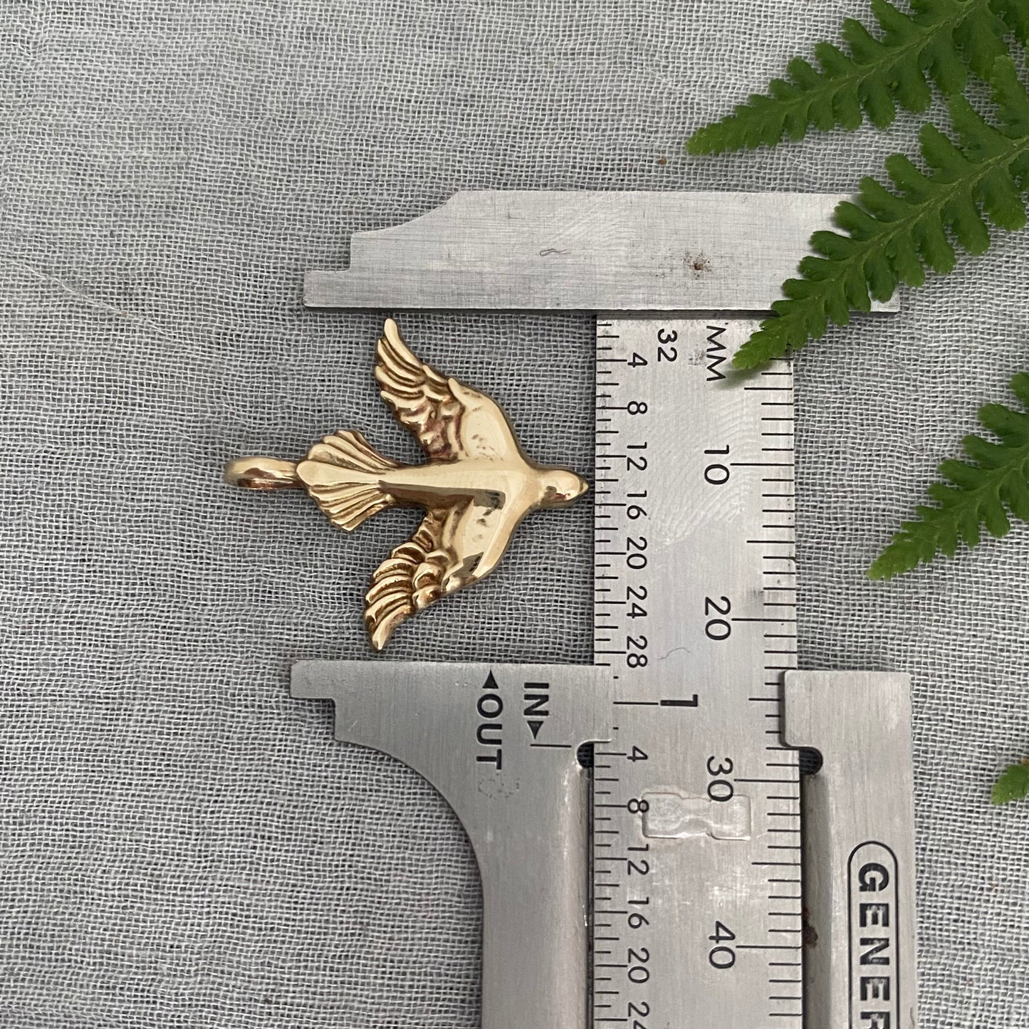 Holy Spirit peace dove pendant necklace gold toned brass dove and chain. It is just under an inch wide and almost an inch long.
