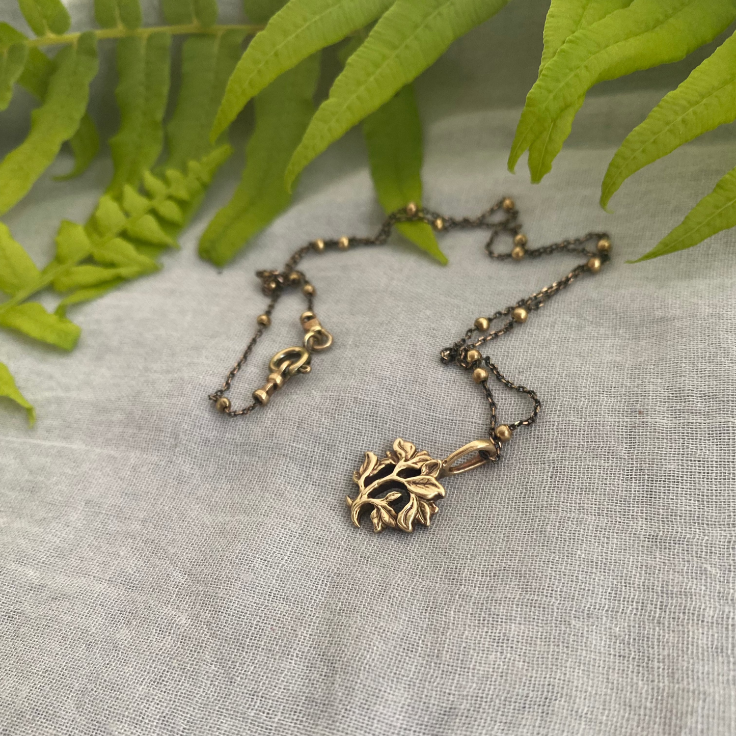 dainty gold-toned tree of life necklace; tiny antiqued brass pendant and chain; gift for nature lover; mythological and Christian symbol