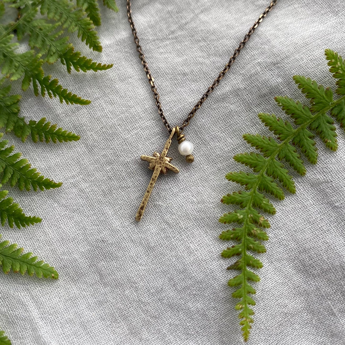 Tiny dainty cross necklace with freshwater pearl; antiqued brass pendant and chain