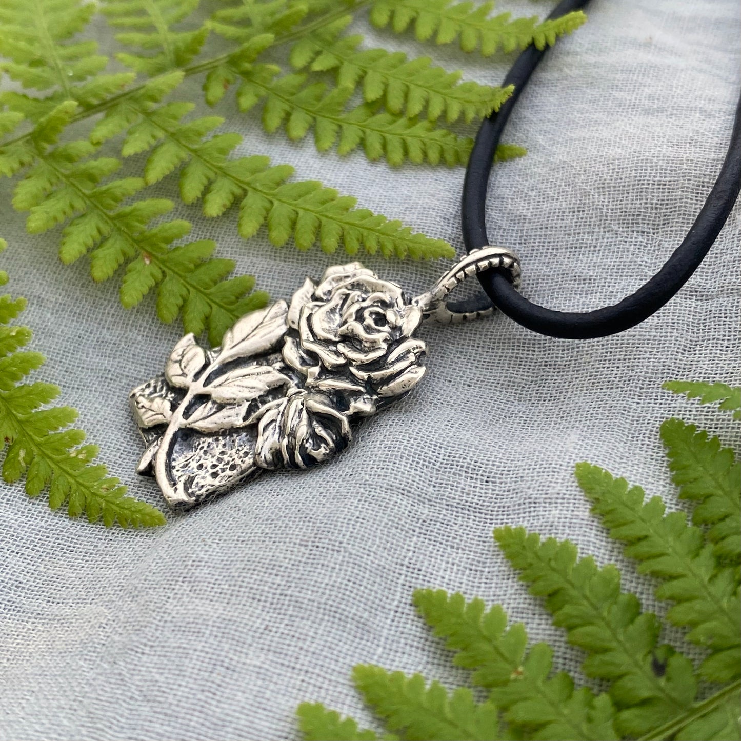 Romantic Victorian style sterling silver rose pendant, black leather cord necklace, hand carved original design with rose, bud, and leaves