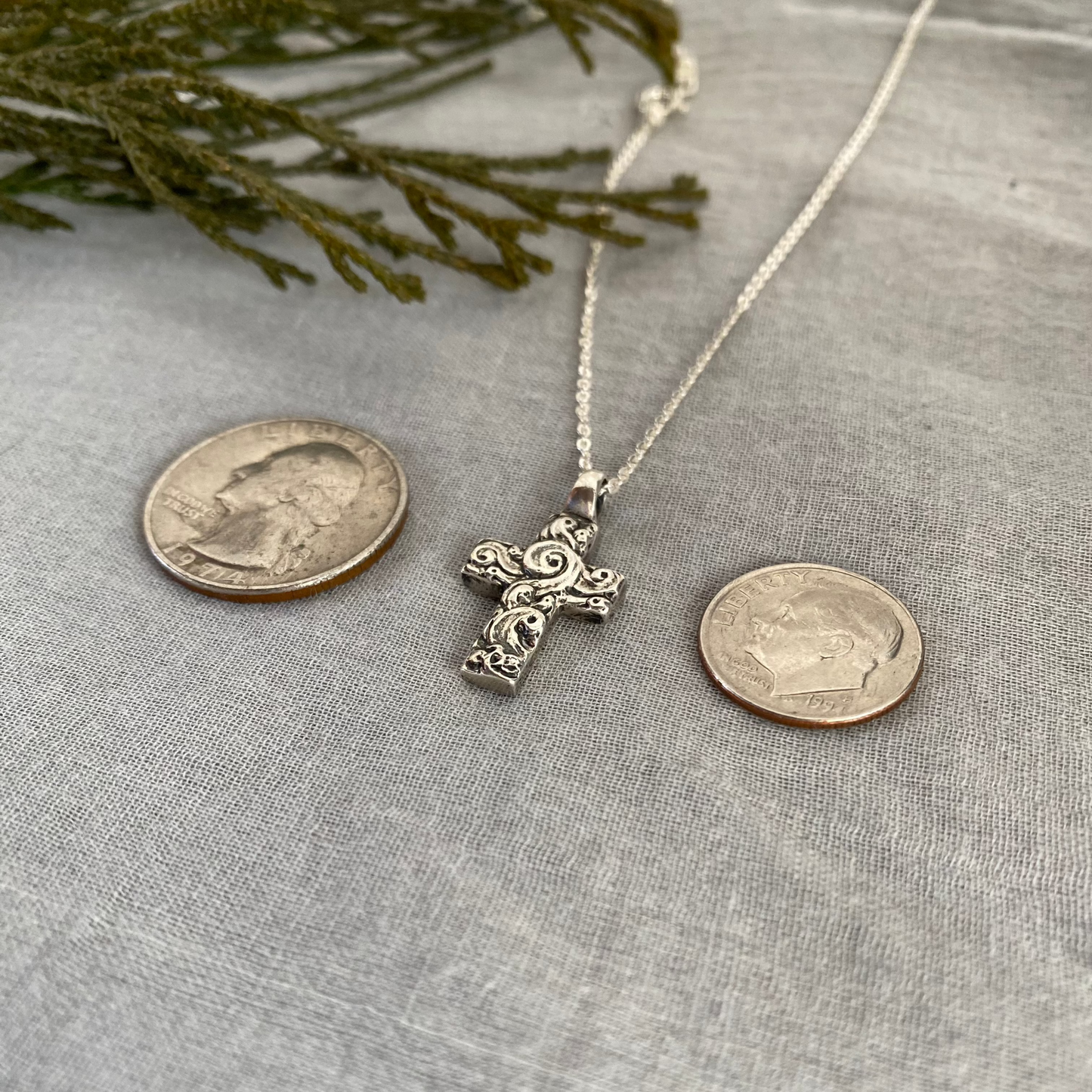 Chunky sterling silver cross necklace with swirling wave design on sterling silver chain