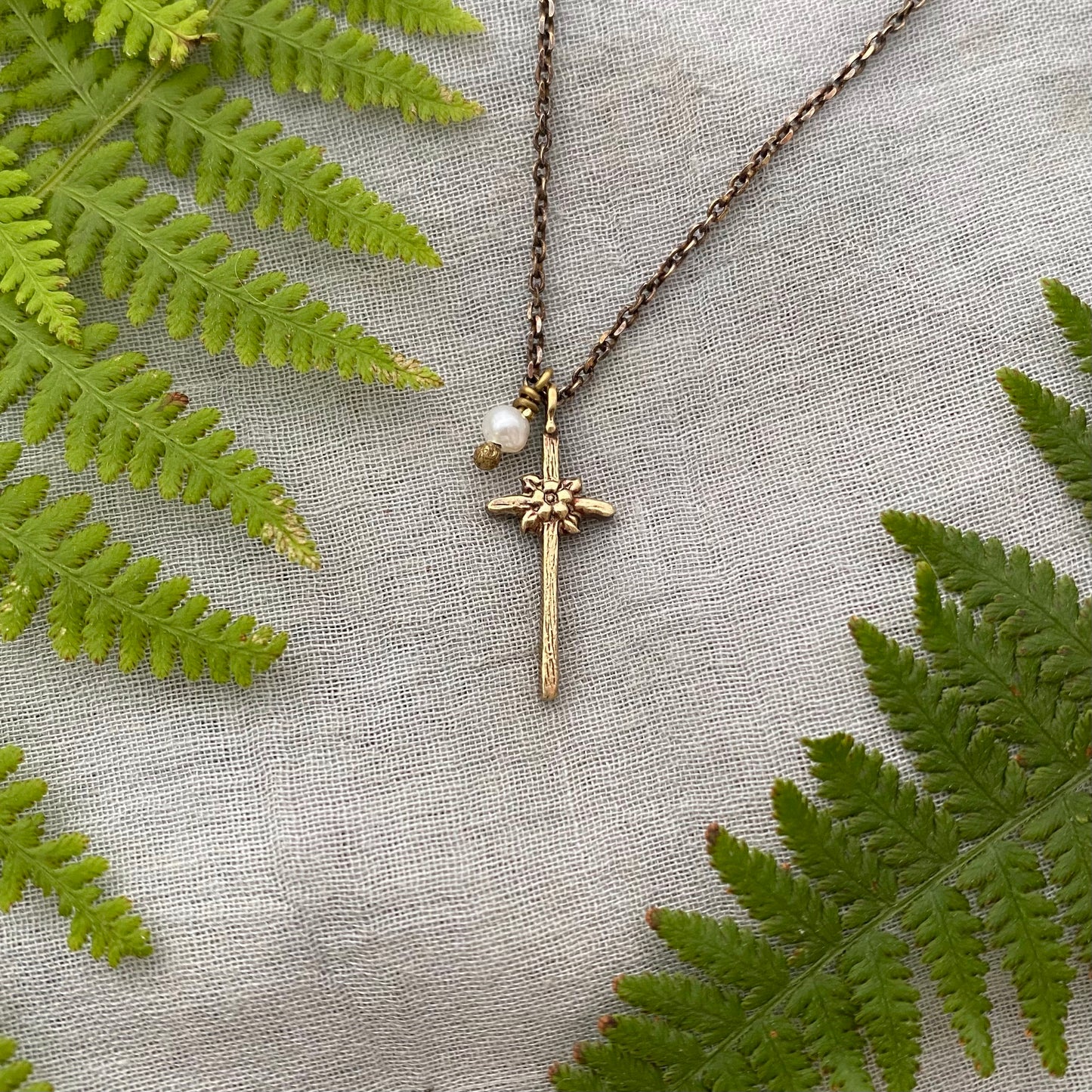 Tiny dainty cross necklace with freshwater pearl; antiqued brass pendant and chain