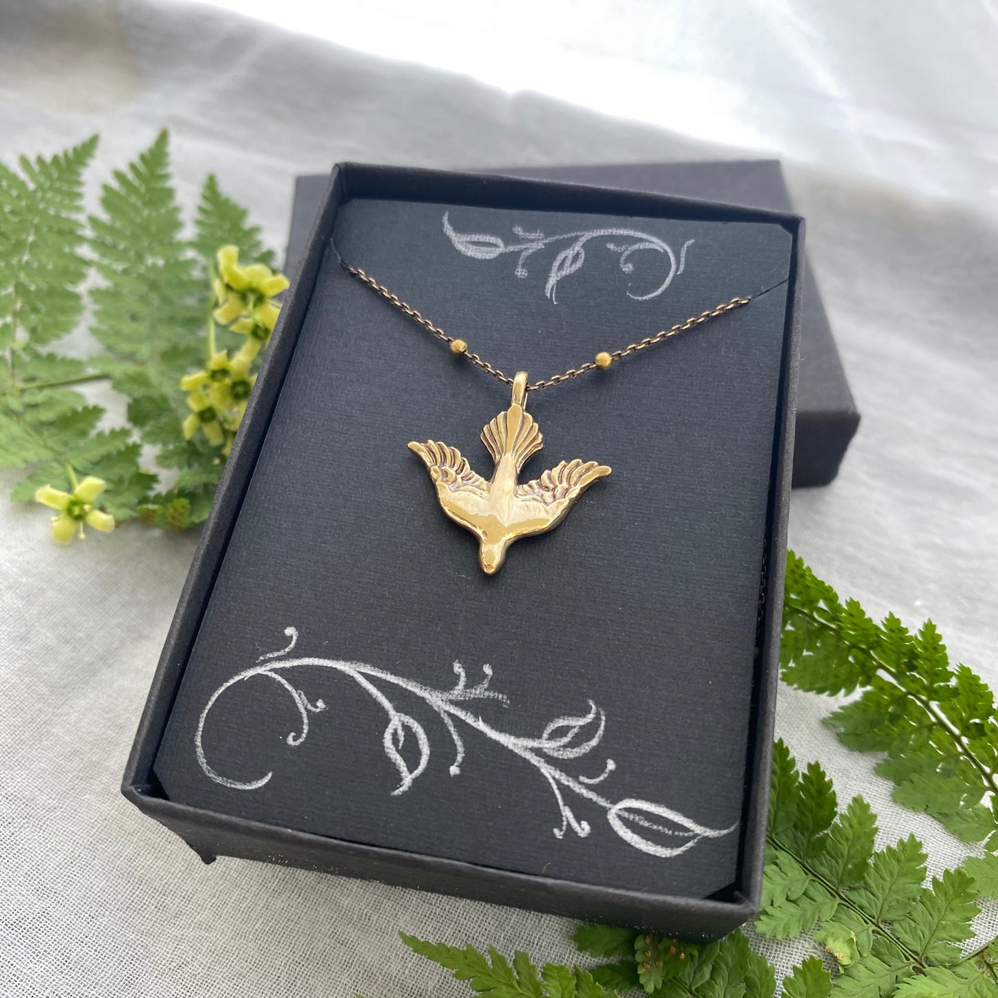 Holy Spirit peace dove pendant necklace gold toned brass dove and chain. It is just under an inch wide and almost an inch long.