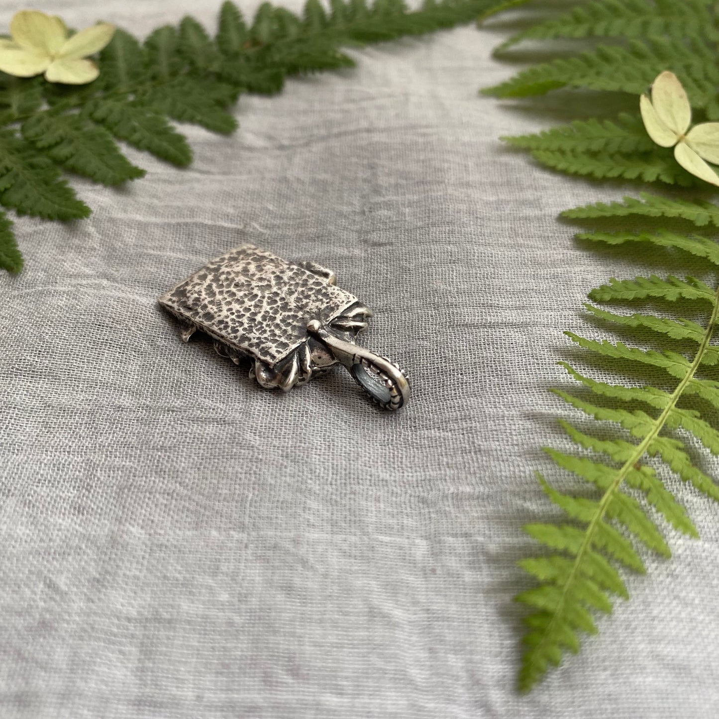 Sculptural silver rose pendant with rosebuds and leaves