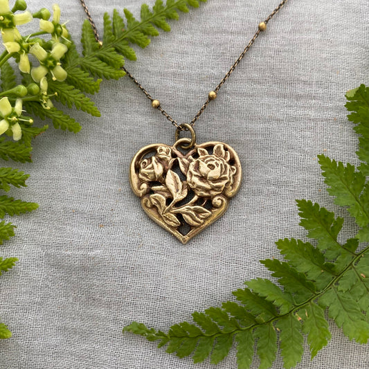 Richly carved Victorian-style brass heart necklace with roses on antiqued brass satellite cable chain