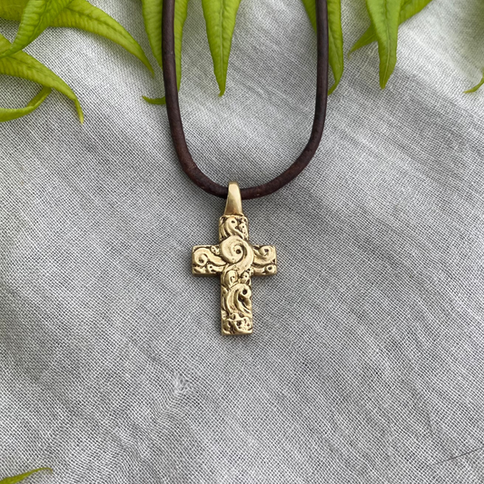 chunky small brass cross on brown leather cord with unique swirling wave design, gift for  men and women, hand carved and produced in USA