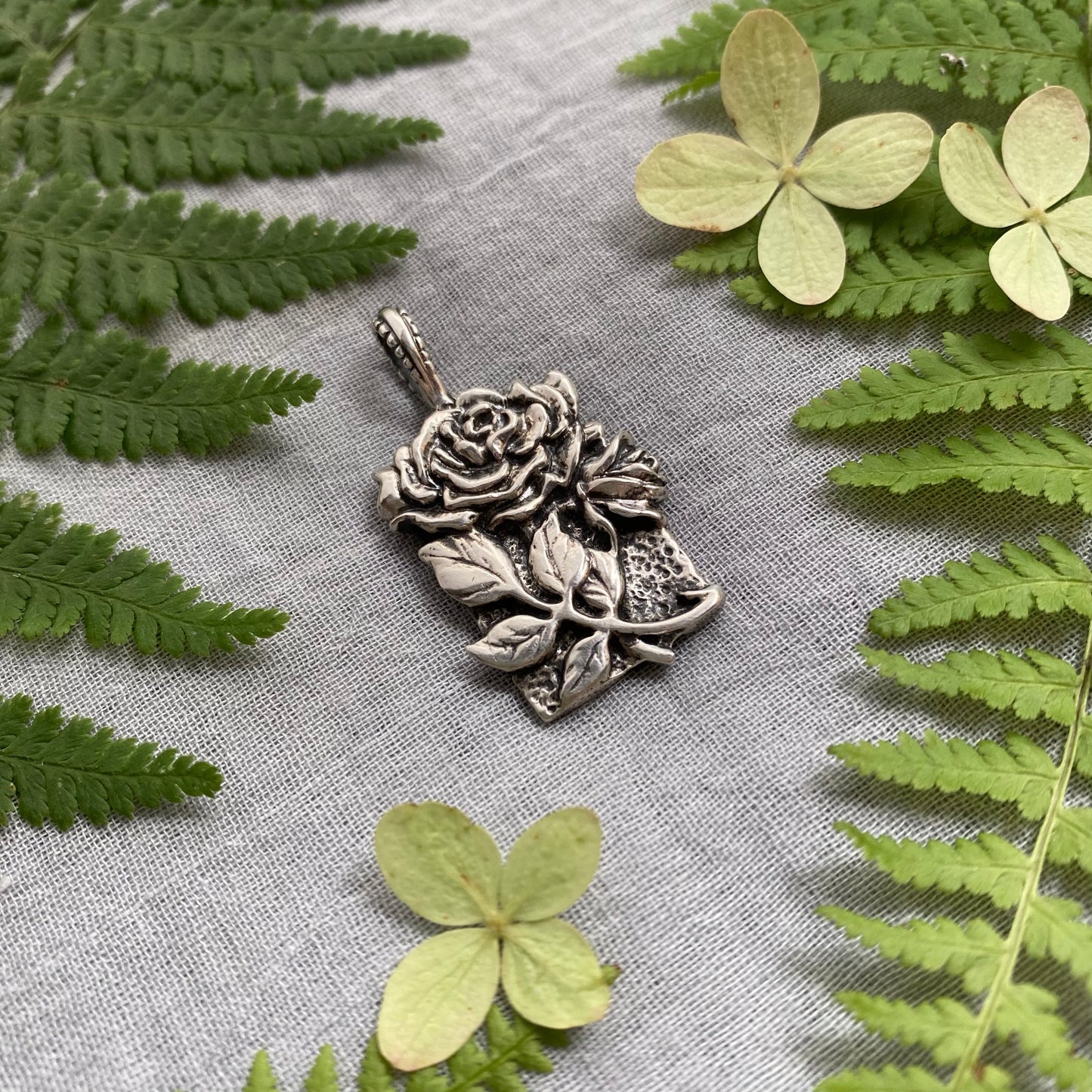 Sculptural silver rose pendant with rosebuds and leaves