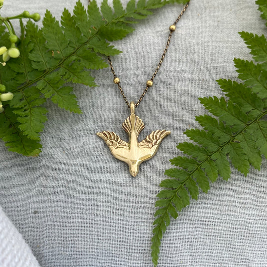 Holy Spirit peace dove pendant necklace gold toned brass dove and chain. It is just under an inch wide and almost an inch long.