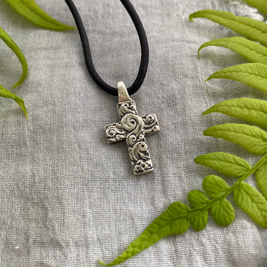 chunky small sterling silver cross on black leather cord with unique swirling wave design, gift for men and women, handcarved and produced in USA