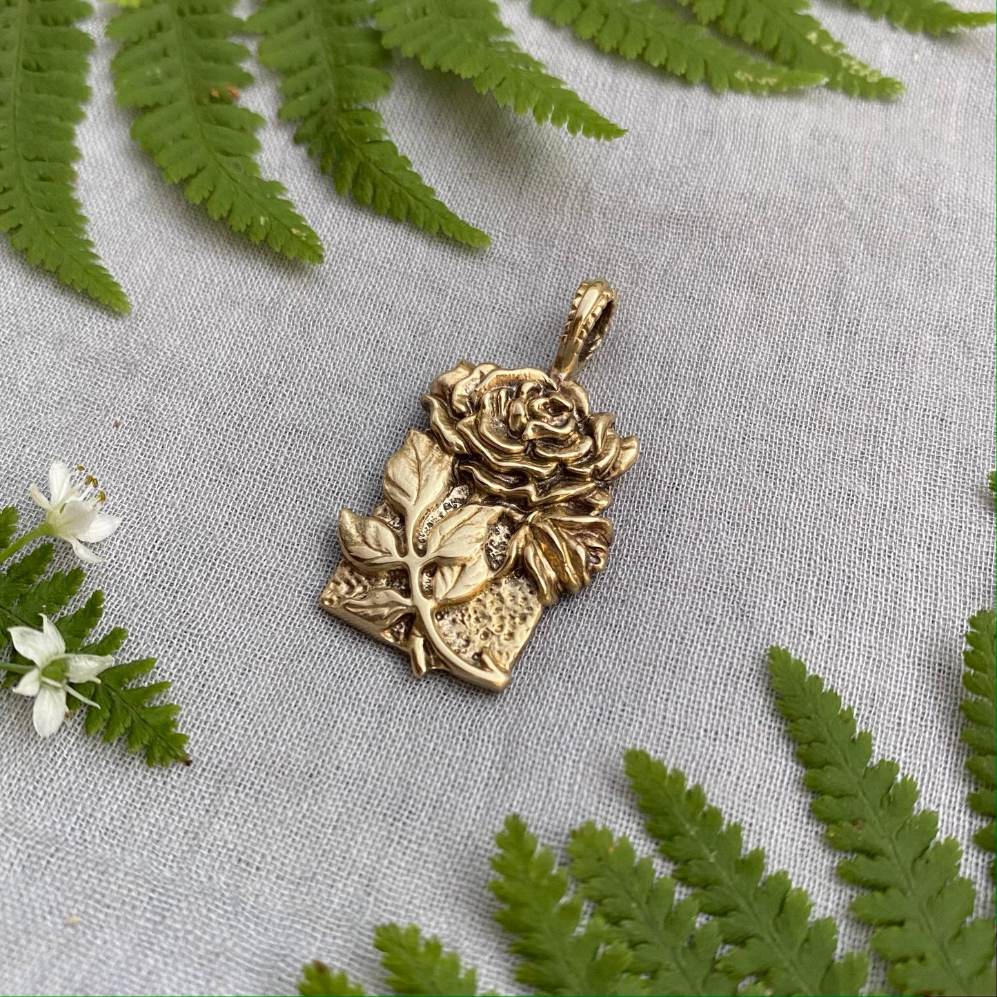 Sculptural brass rose pendant with rosebud and leaves