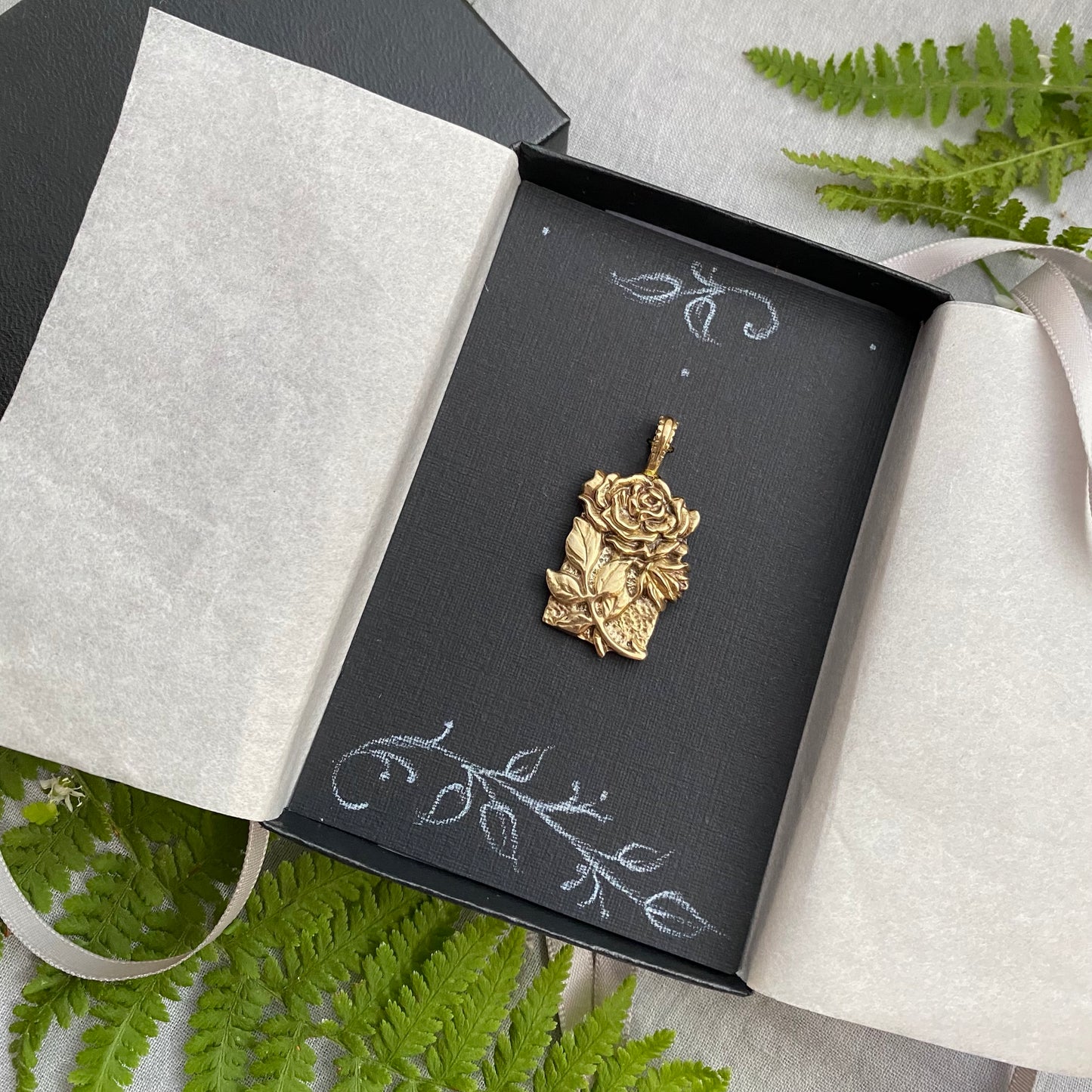 Sculptural brass rose pendant with rosebud and leaves