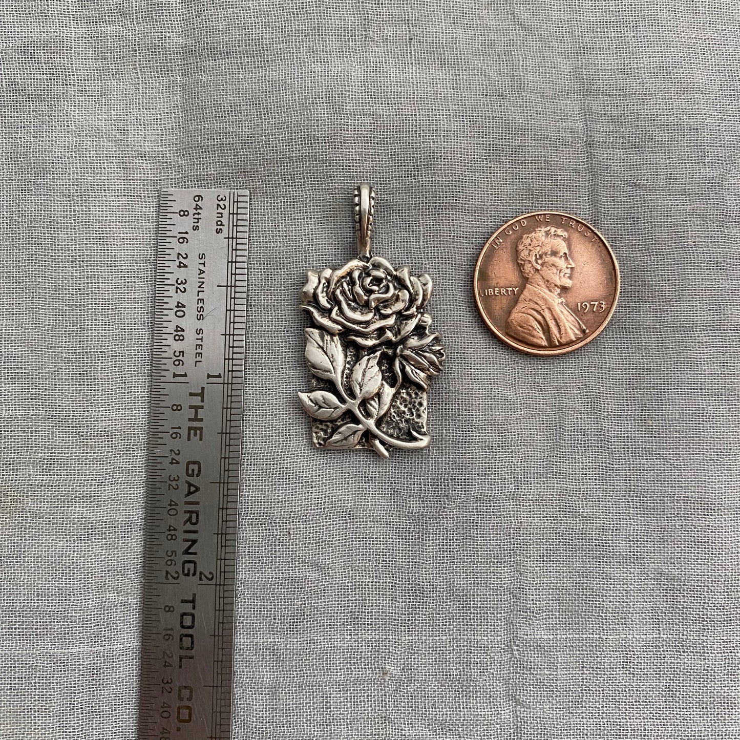 Sculptural silver rose pendant with rosebuds and leaves