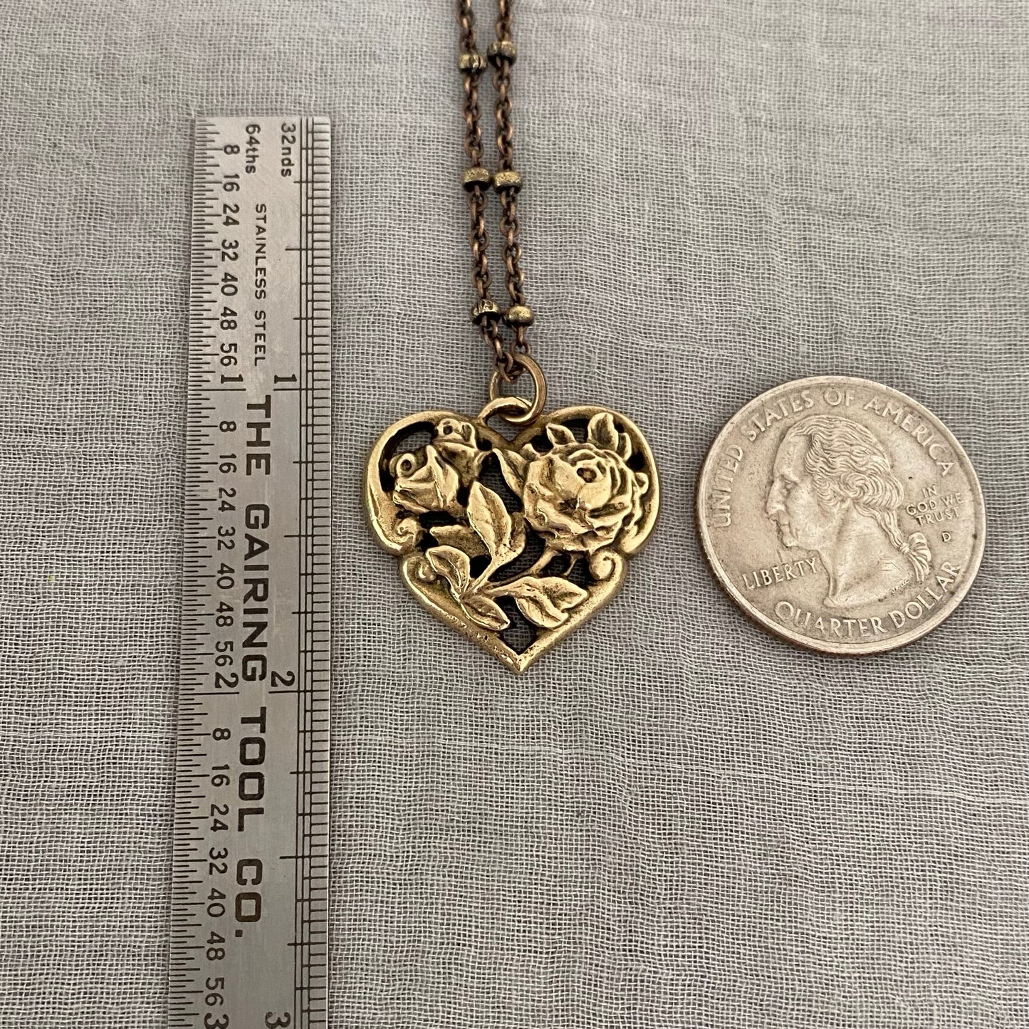 Brass floral heart necklace on satellite chain