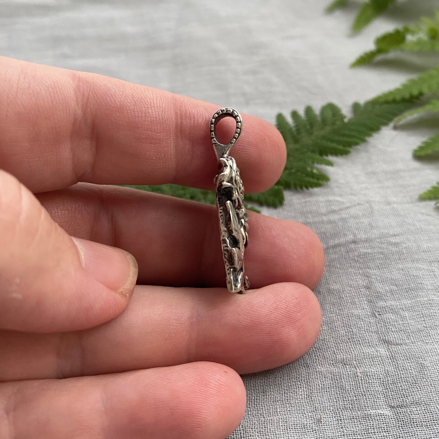 Sculptural silver rose pendant with rosebuds and leaves