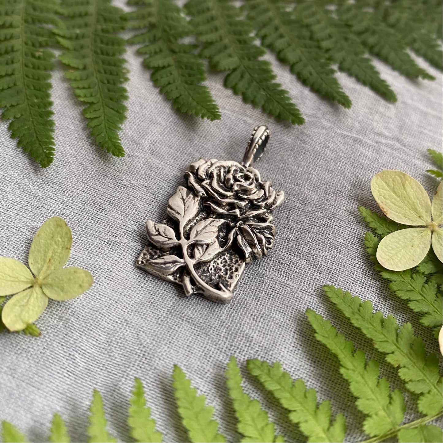 Sculptural silver rose pendant with rosebuds and leaves