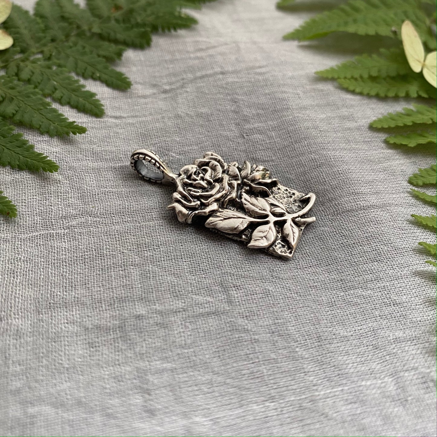 Sculptural silver rose pendant with rosebuds and leaves