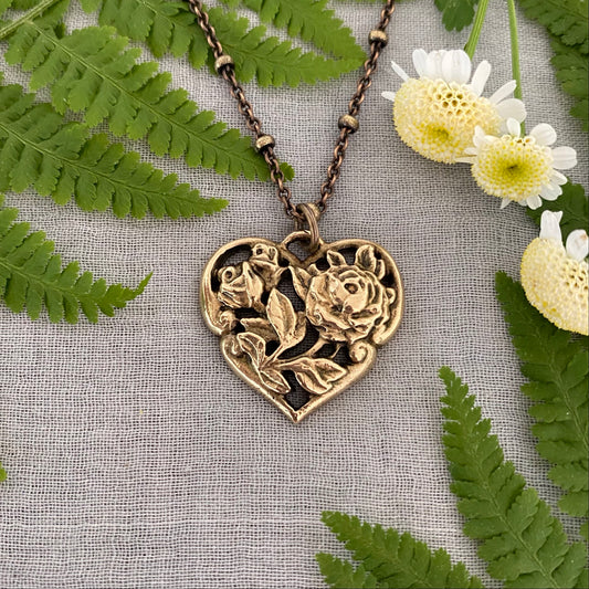 Brass floral heart necklace on satellite chain